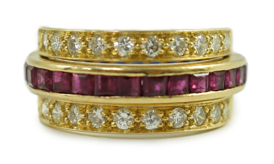 An 18k gold, ruby, sapphire and diamond set triple band swivel ring